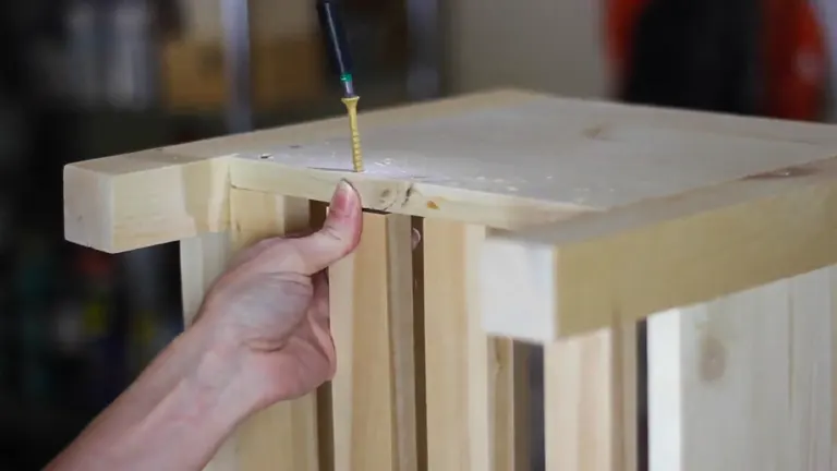 Close-up of screwing a wooden plank on a small hand-crafted table.