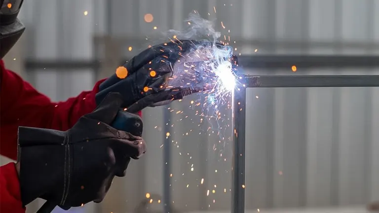 Person welding a metal frame