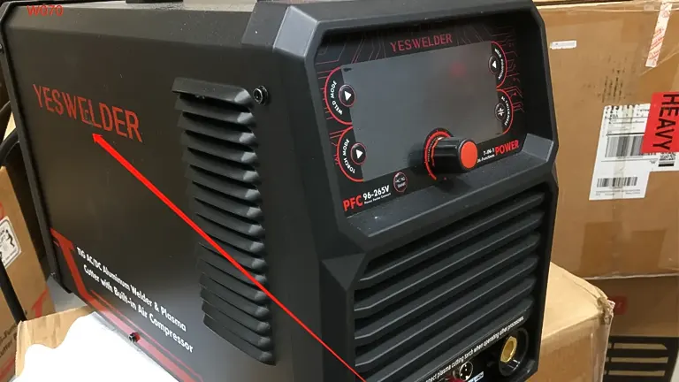 YesWelder Firstess CT2050 welding machine with control knobs and connectors, placed on a box