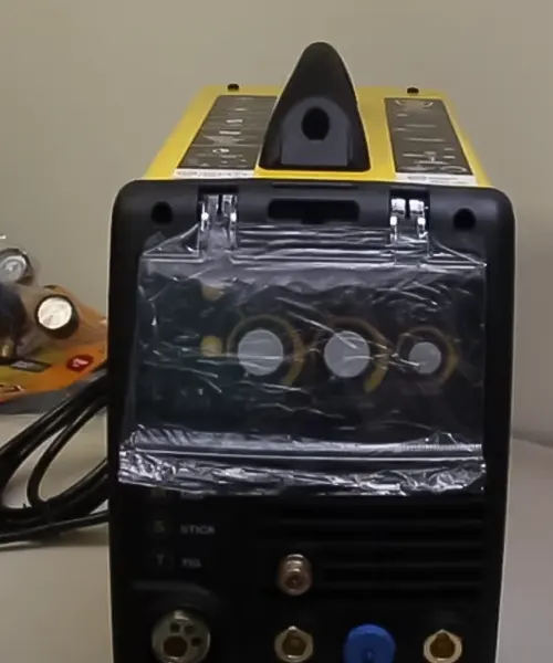 Bossweld MST-185 Plus 3-In-1 Inverter Welder with visible internal components and accessories, dials, connectors, and a handle for transportation