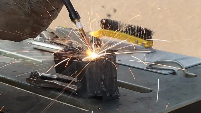 person using a Chicago Electric Flux 125 Welder to weld a metal piece