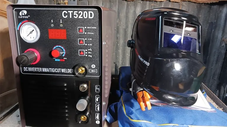 LOTOS CT520D Plasma Cutter and TIG Welder alongside a welding helmet and gloves