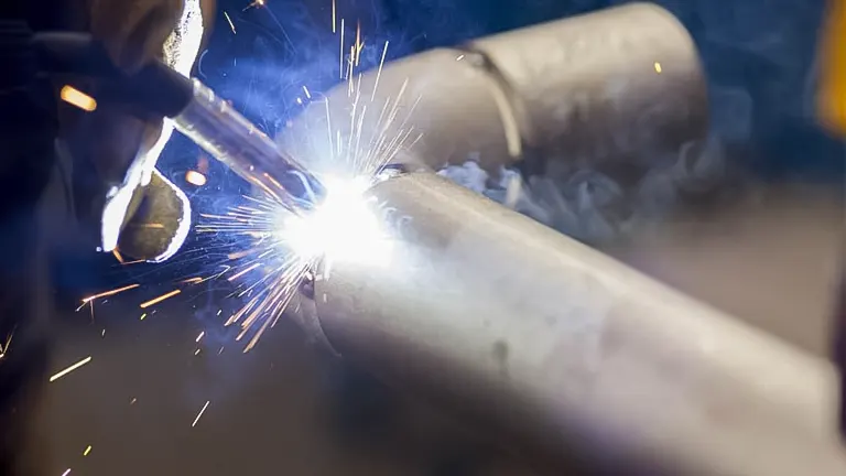 a welder skillfully preparing a joint on a metal pipe