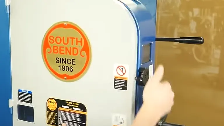 close-up of a blue and white “South Bend” heavy-duty bandsaw, model SB1080