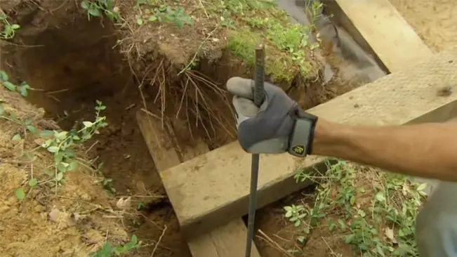 How to Build a Retaining Wall with Landscape Timbers securing timbers with rebars