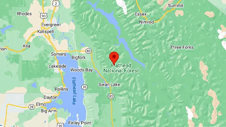 A map displaying a section of the Flathead National Forest area, with a red marker indicating a specific location within the forest. Surrounding areas include Kalispell to the northwest, Bigfork to the northeast, and several bodies of water like Flathead Lake to the southwest.
