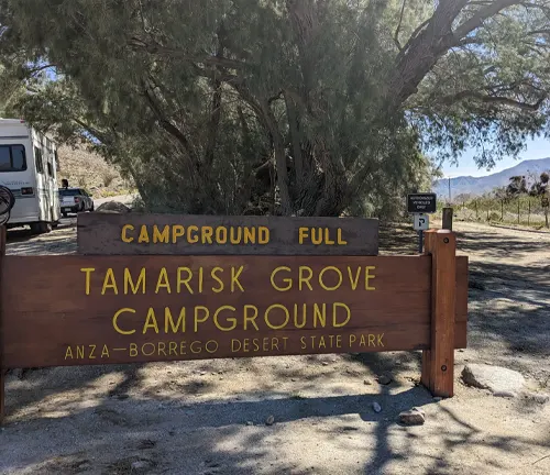 A wooden sign at the entrance of Tamarisk Grove Campground stating "CAMPGROUND FULL" in Anza-Borrego Desert State Park.

