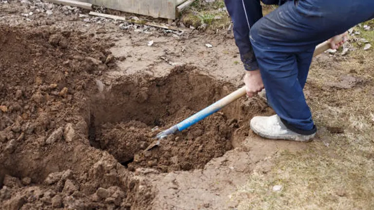 Person digging a planting hole with a shovel