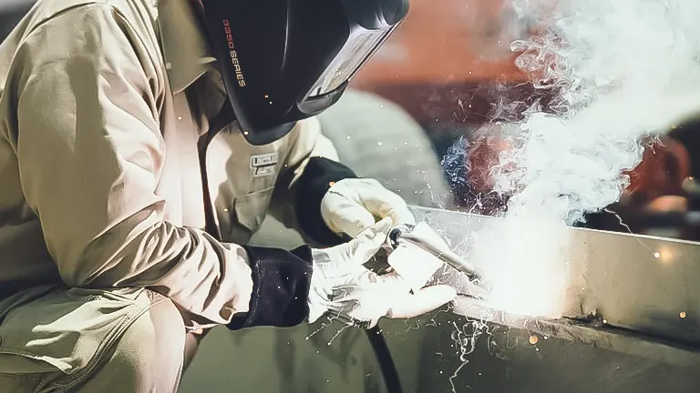Person arc welding with protective gear