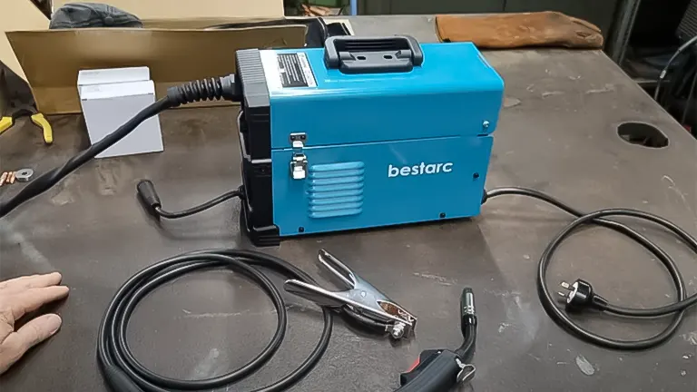bestarc MIG welder on a workbench with grounding clamp and cables