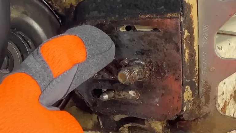 Gloved hand inspecting a rusty mechanical component.