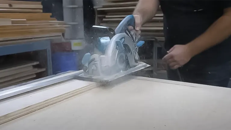 Person using a circular saw with a saw guide to make a straight cut in plywood