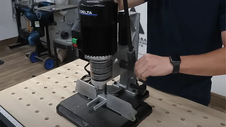 Person using a Delta 1/2 HP Benchtop Mortising Machine
