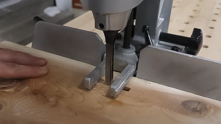 Person using a Delta 1/2 HP Benchtop Mortising Machine on wood