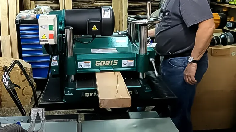 Person using a Grizzly G0815 heavy-duty planer in a woodshop