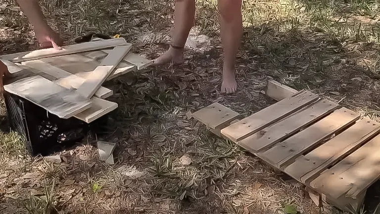 Assembling wooden parts for an A-frame chicken coop on the ground