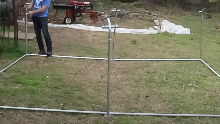 Initial structure of a chicken coop with metal poles erected on grass