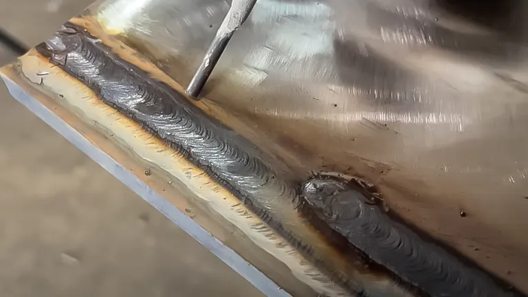 Welding electrode near a metal plate with multiple consistent weld beads