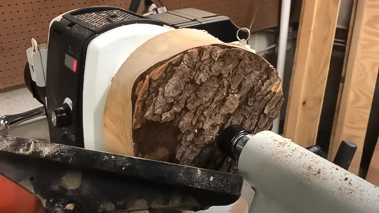 Rough wood piece mounted on a JET JWL-1640EVS lathe with tool rest in the foreground