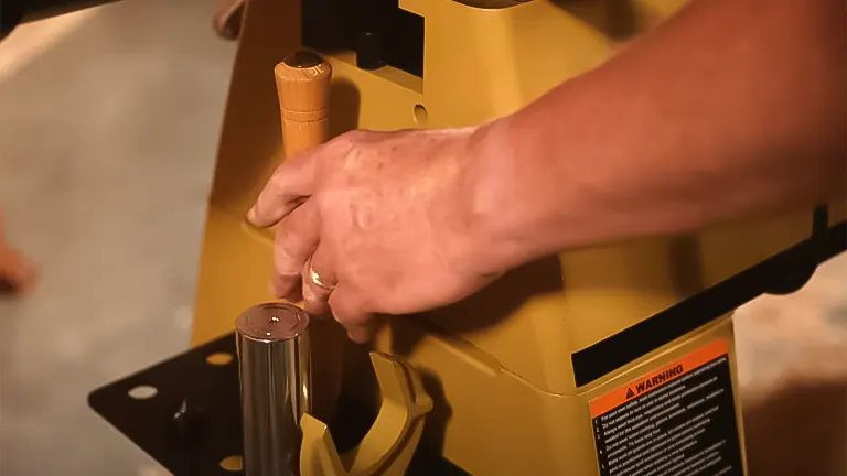 Hands adjusting the tool rest on a Powermatic 3520C wood lathe