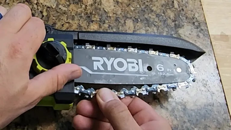Person holding the Ryobi Mini Chainsaw Chain checking for tension
