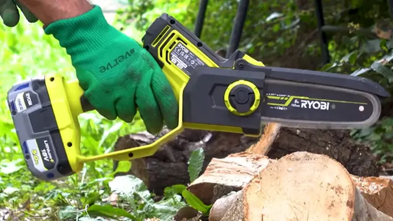 Person  with gloves holding Ryobi Mini Chainsaw preparing to cut log