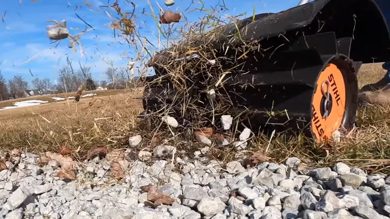 STIHL Rock Sweeper throwing rocks and weeds