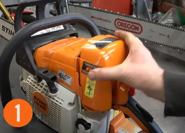 Close-up of a hand adjusting the mode on a Stihl MS 290 chainsaw