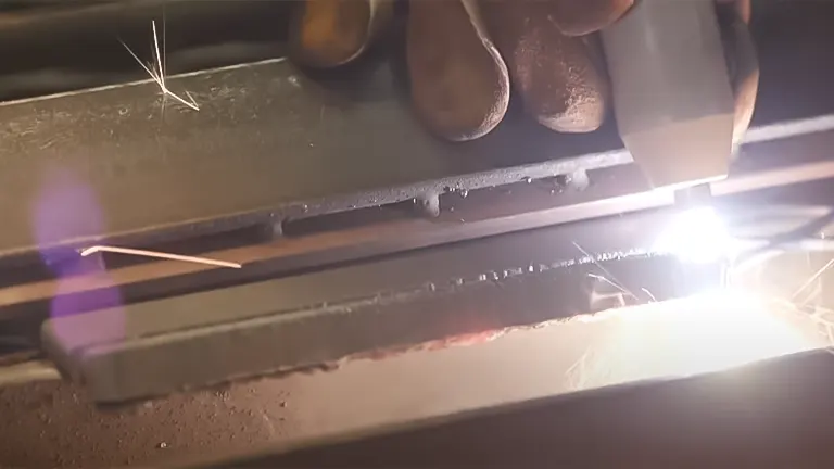 Close-up of a plasma torch cutting through metal with visible sparks