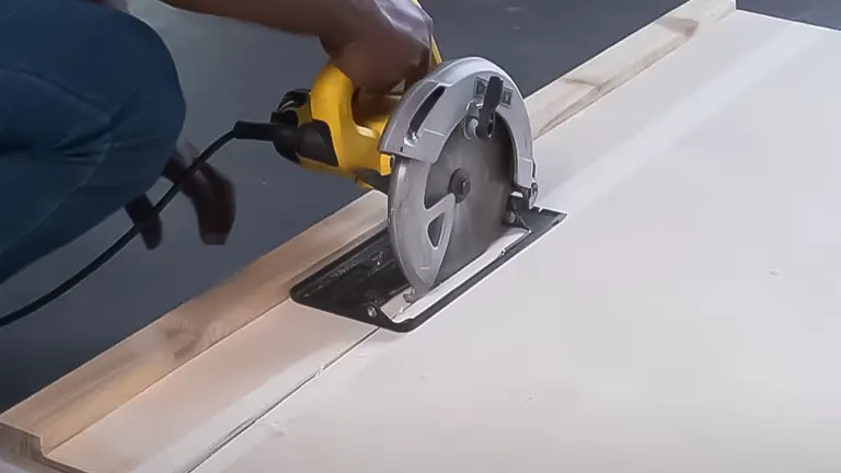Circular saw cutting plywood with wooden guide