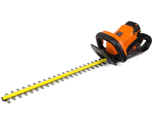 Orange and black electric hedge trimmer isolated on a white background.