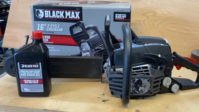BlackMax 16-inch 2-cycle chainsaw and premium bar and chain oil on a wooden table.