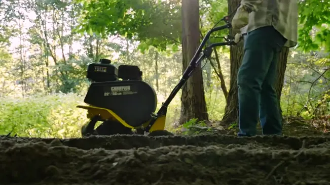 Person operating a Champion tiller in a forest