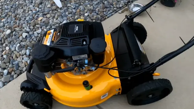 A cub cadet lawnmower on a gravel surface