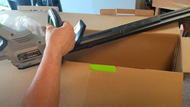 Person unpacking a new vacuum cleaner from a cardboard box