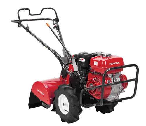 Red Honda tiller with black handles and white wheels