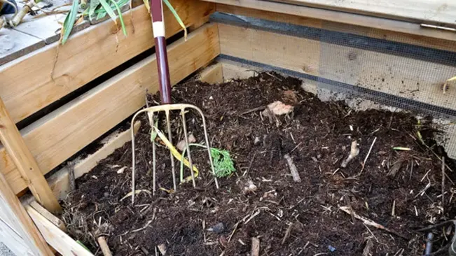 Garden fork in compost bin