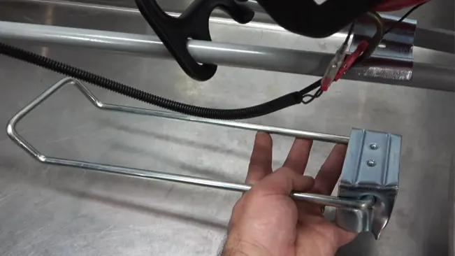 Hand adjusting a metal clamp on a wire rack