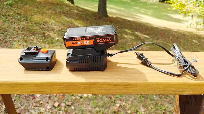 Image of a VEVOR 20V 4A/M Li-Ion battery and charger on a wooden table