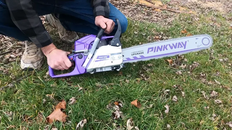 Person holding Pinkway Chainsaw laying on the grass