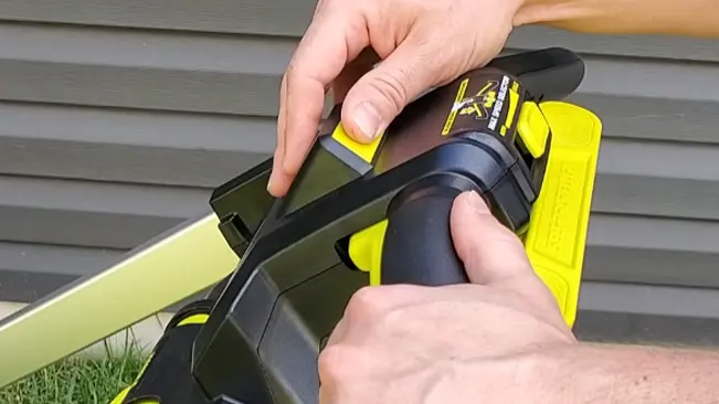 person adjusting a yellow and black power tool