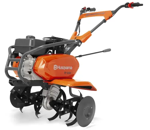 Husqvarna tiller with rotating blades, predominantly orange and black, equipped with handles for control