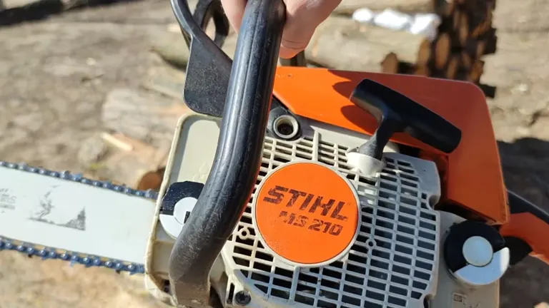 Person holding STIHL MS 210 Chainsaw