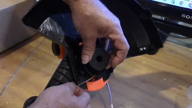Person fixing string trimmer
