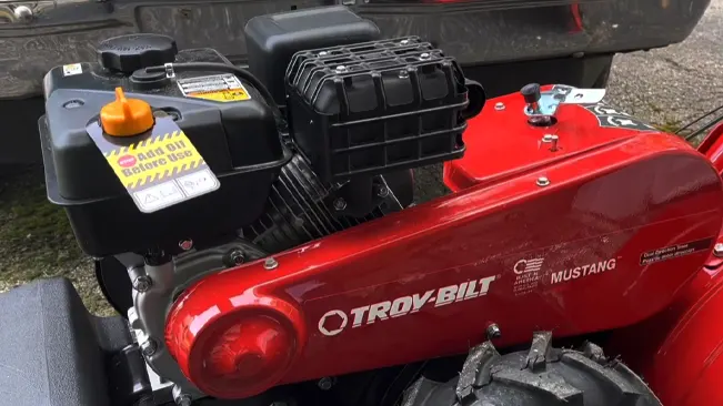 close-up of a Troy-Bilt Mustang engine and part of its red body