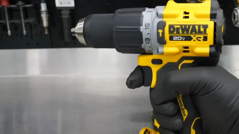 A gloved hand grips a DEWALT 20V Max XR drill, with a focus on the chuck and ergonomic handle, against a workbench backdrop with tools.