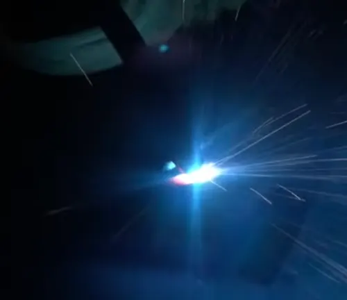 Bright welding arc with sparks, possibly viewed through an Optrel Crystal 2.0 welding helmet lens.