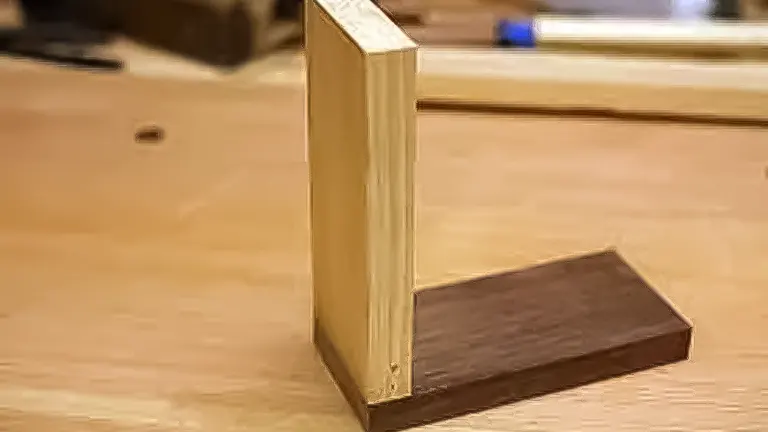 Wooden corner joint on a workbench, demonstrating basic woodworking joinery