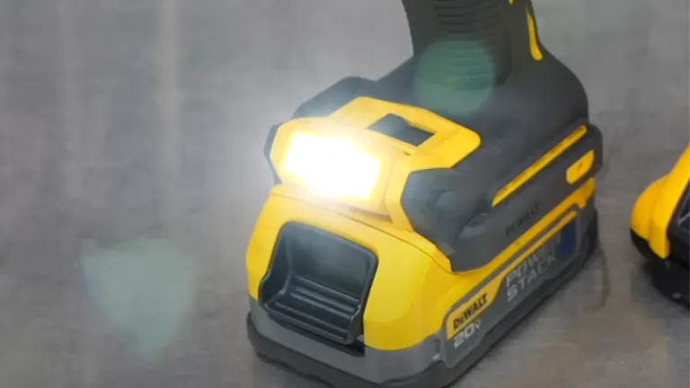 A brightly lit LED on a DEWALT cordless power tool, emphasizing the illumination feature for working in low-light conditions, with the tool's yellow and black design indicative of the brand.