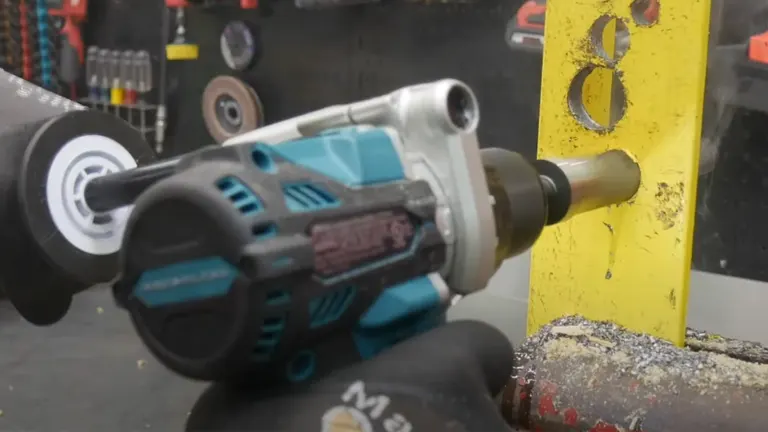 A Makita cordless hammer drill with a drill bit is captured mid-use, creating holes in a bright yellow surface, with visible dust and debris from the drilling.